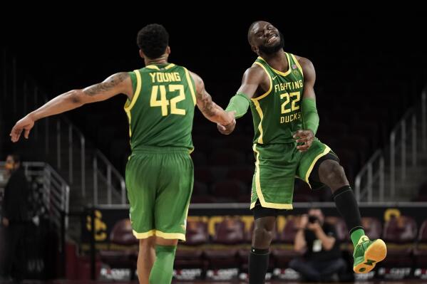 Oregon's Franck Kepnang, right, and Jacob Young celebrate the team's 79-69 win against Southern California in an NCAA college basketball game Saturday, Jan. 15, 2022, in Los Angeles. (AP Photo/Jae C. Hong)