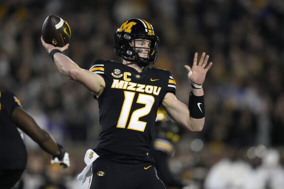 Missouri quarterback Brady Cook throws during the first half of an NCAA college football game against Florida Saturday, Nov. 18, 2023, in Columbia, Mo. (AP Photo/Jeff Roberson)
