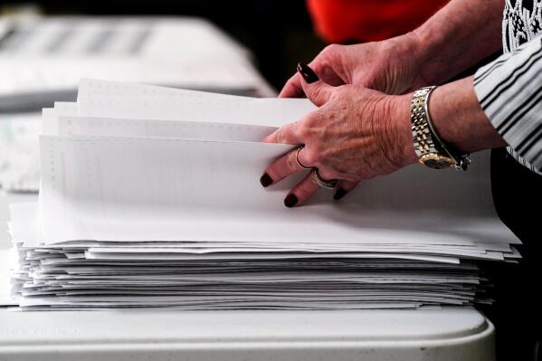 Election workers perform a recount of ballots from the recent primary election at the Montour County administration center in Danville, Pa., Friday, May 27, 2022. (AP Photo/Matt Rourke)