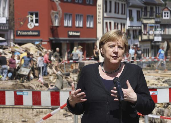 German Chancellor Angela Merkel speaks at a press conference in Muenstereifel, Germany, Tuesday, July 20, 2021. Merkel and North Rhine-Westphalia's Prime Minister Laschet visited Bad Muenstereifel, which was badly affected by the storm. (Oliver Berg/dpa via AP, Pool)