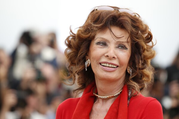 FILE - Italian actress Sophia Loren smiles during a photo call for "Human Voice," (Voce Umana) at the 67th international film festival, Cannes, southern France, on May 21, 2014. Film legend Sophia Loren is recovering from successful surgery for a leg fracture after she fell in her Switzerland home, an agent for the 89-year-old Italian actor said Monday, Sept. 25, 2023. (AP Photo/Alastair Grant, File)