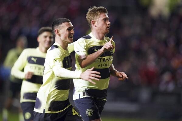 Manchester City's Kevin De Bruyne, right, celebrates scoring their side's third goal with Phil Foden during an English FA Cup fifth-round soccer match between Bristol City and Manchester City at Ashton Gate stadium in Bristol, England, Tuesday, Feb. 28, 2023. (Adam Davy/PA via AP)