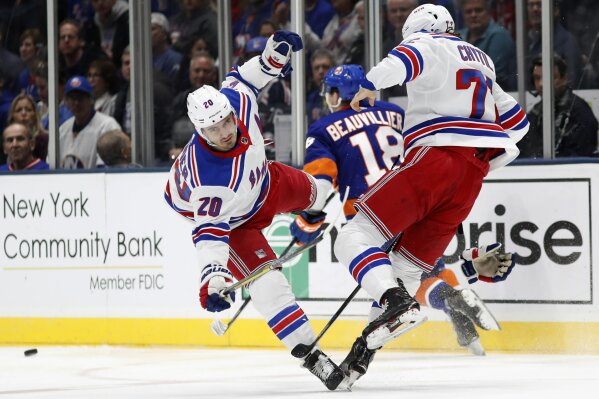 New York Rangers left wing Chris Kreider (20) and center Filip Chytil (72) collide as New York Islanders left wing Anthony Beauvillier (18) skates between them during the first period of an NHL hockey game, Tuesday, Feb. 25, 2020, in Uniondale, N.Y. (AP Photo/Kathy Willens)
