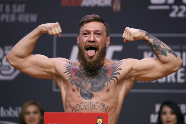 
              FILE - In this Oct. 5, 2018, file photo, Conor McGregor poses during a ceremonial weigh-in for the UFC 229 mixed martial arts fight in Las Vegas.  Superstar UFC fighter McGregor has announced on social media that he is retiring from mixed martial arts. McGregor’s verified Twitter account had a post early Tuesday, March 26, 2019,  that said the former featherweight and lightweight UFC champion was making a “quick announcement.”(AP Photo/John Locher, File)
            