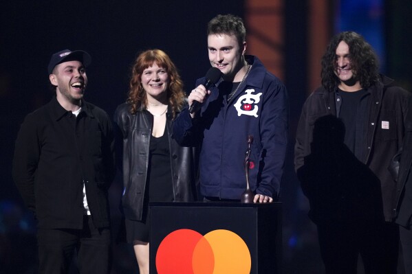 Sam Fender, centre, accepts the best rock/alternative act award during the Brit Awards 2025 in London, Saturday, March. 1, 2025. (Photo by Scott A Garfitt/Invision/AP)