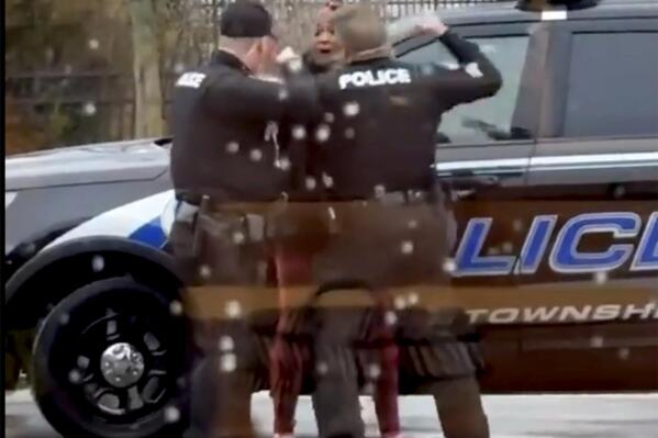 CORRECTS THE SPELLING TO LATICKA HANCOCK FROM LATINKA This screen grab made from video shows Butler Township officers Sgt. Tim Zellers, left, and Todd Stanley, right, restrain and arrest Laticka Hancock outside a McDonald's restaurant in Butler Township, Ohio, on Monday, Jan. 16, 2023. The officers said Hancock resisted arrest, and video shows Stanley strike Hancock. (Mario Robinson/ LOCAL NEWS X /TMX via AP)