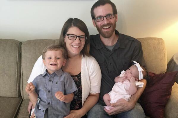 This 2018 photo provided by the family shows Rachel Held Evans and her husband, Dan Evans, with their children, Henry and Harper, in Dayton, Tenn. Rachel, a Christian author, died in May 2019 at the age of 37. (Family Photo via AP)