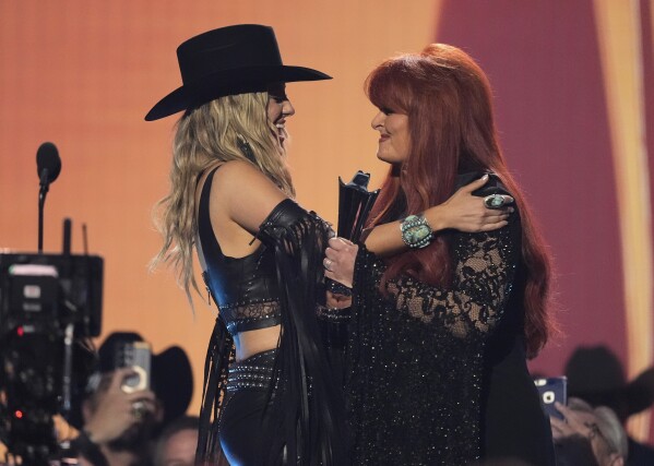 Wynonna Judd, right, presents the award for female artist of the year to Lainey Wilson, left, during the 60th annual Academy of Country Music Awards on Thursday, May 8, 2025, in Frisco, Texas. (AP Photo/Chris Pizzello)
