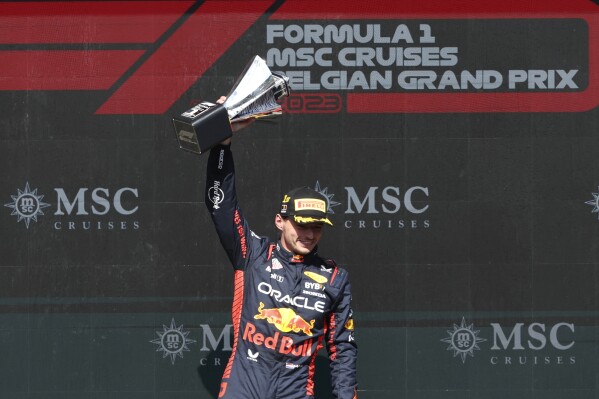 Red Bull driver Max Verstappen of the Netherlands celebrates with his trophy on the podium after winning the Formula One Grand Prix at the Spa-Francorchamps racetrack in Spa, Belgium, Sunday, July 30, 2023. (AP Photo/Geert Vanden Wijngaert)
