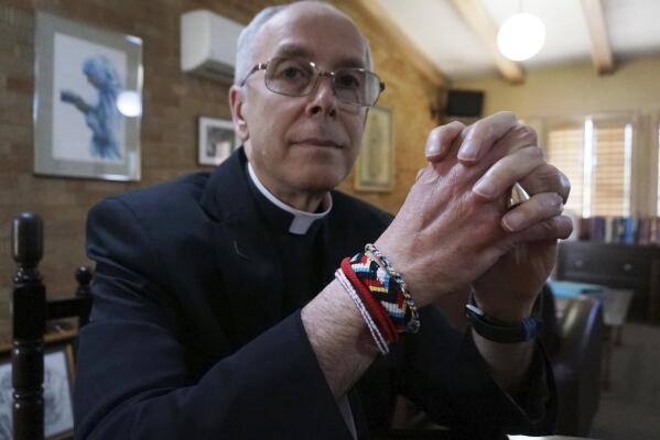 FILE - Bishop Mark Seitz of El Paso sits for a portrait in his office in El Paso, Texas, on April 4, 2022. Seitz, the Roman Catholic bishop of El Paso, Texas, tells The Associated Press that Florida Gov. Ron DeSantis' flights of migrants from the Texas border to California are "reprehensible" and "not morally acceptable." DeSantis' recruiters zeroed in on Sacred Heart Catholic Church in El Paso and its bustling migrant shelter to find asylum-seekers to fly to California's capital city on Florida's taxpayer-funded jets. (AP Photo/Giovanna Dell'Orto, File)