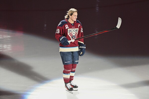 Montreal Victoire's Marie-Philip Poulin salutes the crowd as she is introduced ahead of a PWHL hockey game against the Ottawa Charge in Laval, Quebec, Saturday, Nov. 30, 2024. (Graham Hughes/The Canadian Press via AP, file)
