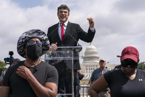 FILE - Joe Kent, center, a Republican who is challenging Rep. Jaime Herrera Beutler, R-Wash., for her seat in Washington's 3rd Congressional District, speaks during a "Justice For J6" rally near the U.S. Capitol in Washington, on Sept. 18, 2021, in support of people who took part in the Jan. 6 insurrection at the U.S. Capitol. Kent has openly displayed ties to far-right and extremist organizations in his election run. That includes groups that have drawn law enforcement scrutiny over their involvement in the Jan. 6. insurrection (AP Photo/Nathan Howard, File)