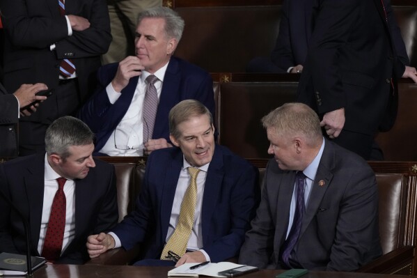 Rep. Jim Jordan, R-Ohio, chairman of the House Judiciary Committee, seated center, talks to Rep. Warren Davidson, R-Ohio, right, and a House staff member, left, as Republicans try to elect Jordan, a top Donald Trump ally, to be the new House speaker, at the Capitol in Washington, Tuesday, Oct. 17, 2023, as former Speaker of the House Rep. Kevin McCarthy, R-Calif., sits behind them. (AP Photo/J. Scott Applewhite)