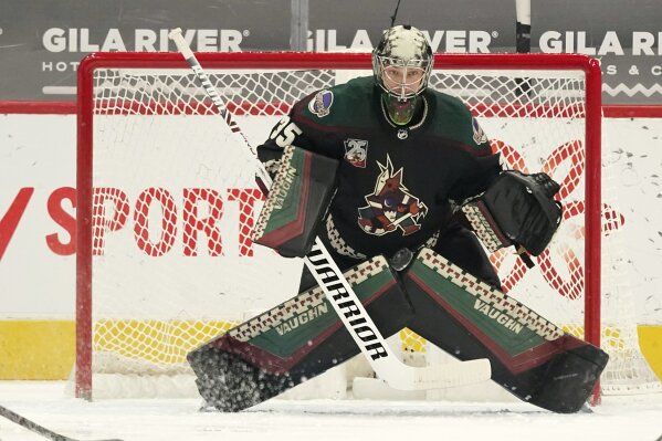 Arizona Coyotes goaltender Darcy Kuemper tries to find the puck shot by St. Louis Blues' Sammy Blais, but gives up the goal during the first period of an NHL hockey game Saturday, April 17, 2021, in Glendale, Ariz. (AP Photo/Ross D. Franklin)