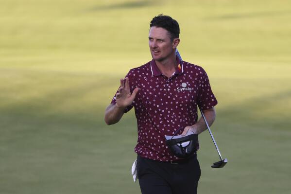England's Justin Rose gestures to the crowd after putting on the 18th green during the second round of the British Open Golf Championship at Royal St George's golf course Sandwich, England, Friday, July 16, 2021. (AP Photo/Ian Walton)
