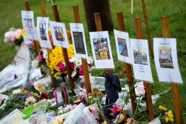 FILE - Rain soaked memorials for those who died sit along the roadside by Schemengees Bar & Grille, Oct. 30, 2023, in Lewiston, Maine. On Monday, Jan. 29, 2024, a Maine legislative committee considered an emergency request to grant powers to a panel investigating last year's Lewiston mass shooting that the state's governor said are critical to unraveling how the killings unfolded. (AP Photo/Matt York, File)