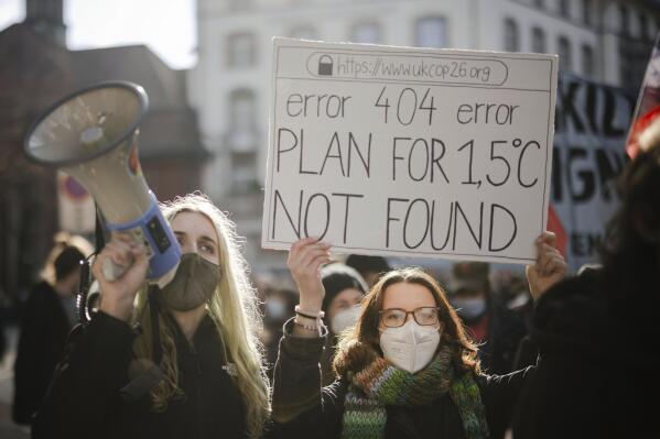 FILE - People attend a Climate Strike demonstration in Zurich, Switzerland, Nov. 6, 2021. The overarching phrase that dominates Glasgow climate talks is simply a number: 1.5. That's the chief but elusive goal of negotiations. It's keeping warming to 1.5 degrees Celsius since pre-industrial times.  (Michael Buholzer/Keystone via AP, File)