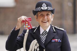 FILE - In this Wednesday July 14, 2021 file photo, Britain's Metropolitan Police Commissioner Cressida Dick poses for her photo after she was made a Dame Commander of the Order of the British Empire, at St James's Palace in central London. The British government on Friday, Sept, 10 says the country's most senior police officer will stay in her job for another two years. Metropolitan Police Commissioner Cressida Dick will remain at the helm of the London force until April 2024. (Kirsty O'Connor/Pool Photo via AP, file)