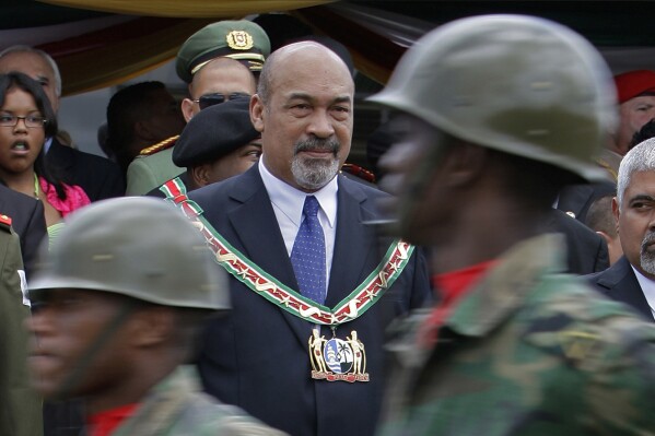 FILE - In this Aug. 12, 2010 file photo, Suriname's President Desi Bouterse attends a military parade after his swearing-in ceremony in Paramaribo, Suriname. Suriname’s former dictator will face a final verdict in Dec 2024 in the years-long judicial process over the 1982 killings of 15 political opponents that deeply scarred the South American country. (AP Photo/Andres Leighton, File)