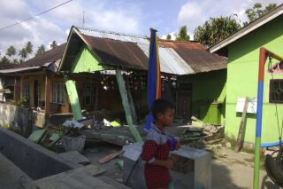 
              In this photo released by the Disaster Management Agency, a house sits damaged after a magnitude 6.1 earthquake early Friday, Sept. 28, 2018, in Donggala, central Sulawesi, Indonesia. Powerful earthquakes jolted the Indonesian island of Sulawesi on Friday, damaging houses and briefly triggered a tsunami warning. (Disaster Management Agency via AP)
            