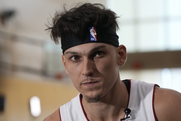 Miami Heat guard Tyler Herro (14) listens during an interview as part of the NBA basketball team's media day, in Miami, Monday, Oct. 2, 2023. (AP Photo/Rebecca Blackwell)