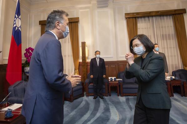 In this photo released by the Taiwan Presidential Office, U.S. Representative Mark Takano, D-Calif. left is greeted by Taiwanese President Tsai Ing-wen at the Presidential Office in Taipei, Taiwan on Friday, Nov. 26, 2021. Five U.S. lawmakers met with Taiwan President Tsai Ing-wen Friday morning in a surprise one-day visit intended to reaffirm the United States' "rock solid" support for the self-governing island. (Taiwan Presidential Office via AP)