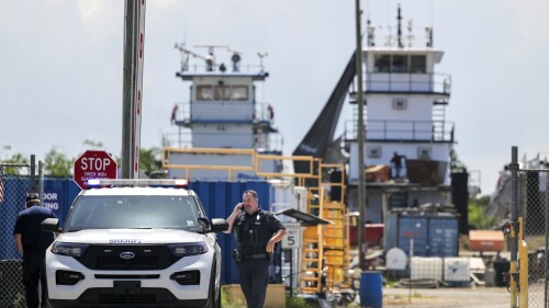 A Jefferson Parish sheriff's deputy is seen at FMT Shipyard and Repair after two employees were shot and killed in Harvey, La., Monday, July 17, 2023. (Brett Duke/The Times-Picayune/The New Orleans Advocate via AP)