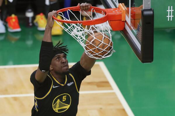 FILE - Golden State Warriors center Kevon Looney (5) dunks the ball against the Boston Celtics during the second quarter of Game 3 of basketball's NBA Finals, Wednesday, June 8, 2022, in Boston. The NBA's free agency period opens Thursday night, June 30, 2022, with teams and players finally free to negotiate new deals. (AP Photo/Michael Dwyer, File)