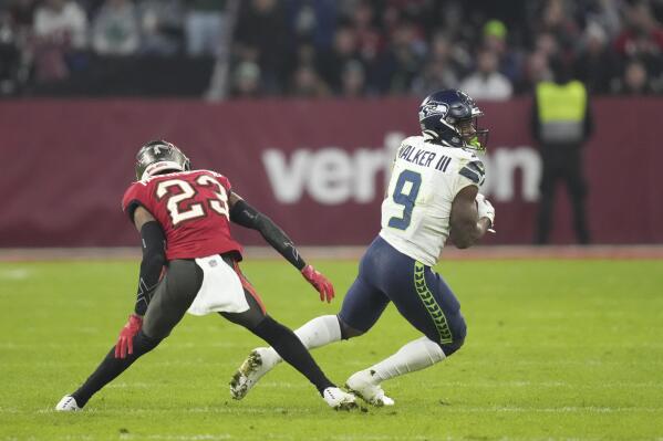 Seattle Seahawks' Kenneth Walker III (9) is defended by Tampa Bay Buccaneers' Sean Murphy-Bunting during the second half of an NFL football game, Sunday, Nov. 13, 2022, in Munich, Germany. (AP Photo/Matthias Schrader)