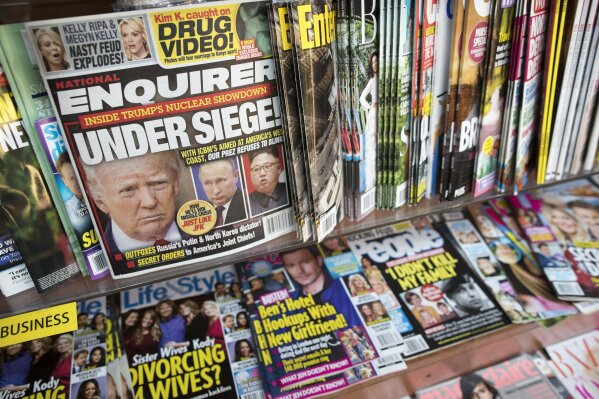 
              FILE - In this July 12, 2017 file photo, an issue of the National Enquirer featuring President Donald Trump on its cover is displayed on a newsstand in a store in New York. The tabloid's owner, American Media announced Thursday, April 18, 2019, that it is selling the supermarket weekly to James Cohen, the former head of the airport newsstand company Hudson News. (AP Photo/Mary Altaffer, File)
            