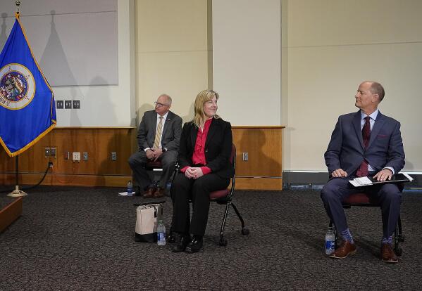 Minnesota Senate Majority Leader Paul Gazelka, R-East Gull Lake, right, and House Speaker Melissa Hortman, DFL-Brooklyn Park, middle, exchanged glances as Minnesota Gov. Tim Walz sat nearby during a press conference Monday, May 17, 2021, in St. Paul, Minn., announcing the Legislature and Walz agreed to spend $52 billion on the next two-year budget. (David Joles/Star Tribune via AP)