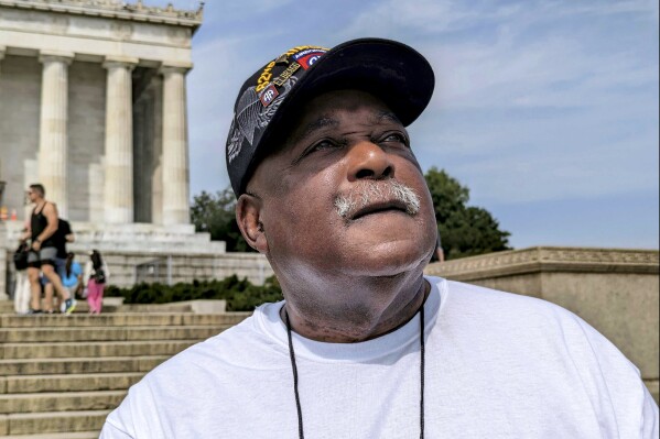 Tommie Babbs, 72, looks out across the reflecting pond by the Lincoln Memorial in Washington on Aug. 11, 2023. Babbs, an Air Force veteran from Buffalo, N.Y., believes progress has been made toward achieving the dream that the Rev. Dr. Martin Luther King Jr. envisioned on the steps of the memorial nearly 60 years ago at the March on Washington for Jobs and Freedom. (AP Photo/Nathan Ellgren)