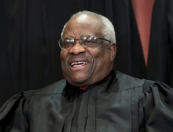 
              FIILE - In this Nov. 30, 2018, file photo, Supreme Court Associate Justice Clarence Thomas, appointed by President George H. W. Bush, sits with fellow Supreme Court justices for a group portrait at the Supreme Court Building in Washington. Thomas is now the longest-serving member of a court that has recently gotten more conservative, putting him in a unique and potentially powerful position, and he’s said he isn’t going away anytime soon. With President Donald Trump’s nominees Neil Gorsuch and Brett Kavanaugh now on the court, conservatives are firmly in control as the justices take on divisive issues such as abortion, gun control and LGBT rights. (AP Photo/J. Scott Applewhite, File)
            
