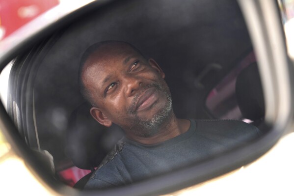 Luizmar Santana Pereira, a former Ford employee who registered for a job with BYD, attends an interview with The Associated Press, in Camacari, Bahia state, Brazil, Saturday, March 8, 2025. (AP Photo/Eraldo Peres)