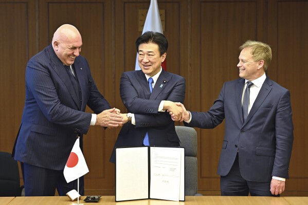 Britain's Defense Minister Grant Shapps, right, Italy's Defense Minister Guido Crosetto, left, and Japanese Defense Minister Minoru Kihara, center, shake hands after a signing ceremony for the Global Combat Air Programme (GCAP) at the defense ministry, Dec. 14, 2023, in Tokyo, Japan. (David Mareuil/Pool Photo via AP, File)