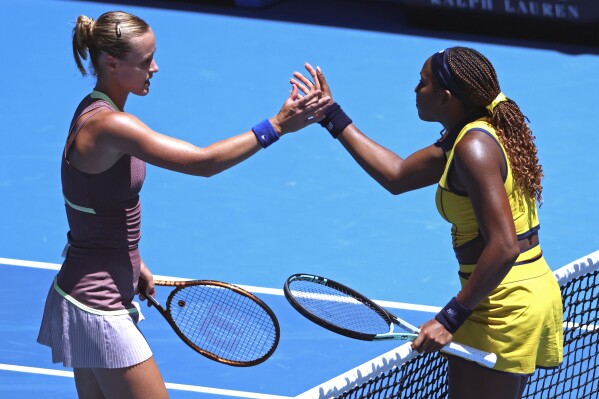 Coco Gauff, right, of the U.S. is congratulated by Anna Karolina Schmiedlova of Slovakia following their first round match at the Australian Open tennis championships at Melbourne Park, Melbourne, Australia, Monday, Jan. 15, 2024. (AP Photo/Asanka Brendon Ratnayake)