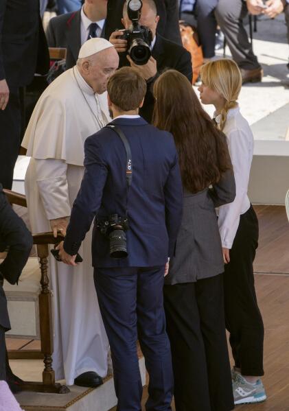 Kateryna Prokopenko, right, wife of Azov Battalion Commander Denys Prokopenko, and Yuliia Fedosiuk, second from right, from Ukraine, talk with Pope Francis, at the end of the weekly general audience, in St. Peter's Square at The Vatican, Wednesday, May 11, 2022. (AP Photo/Domenico Stinellis)