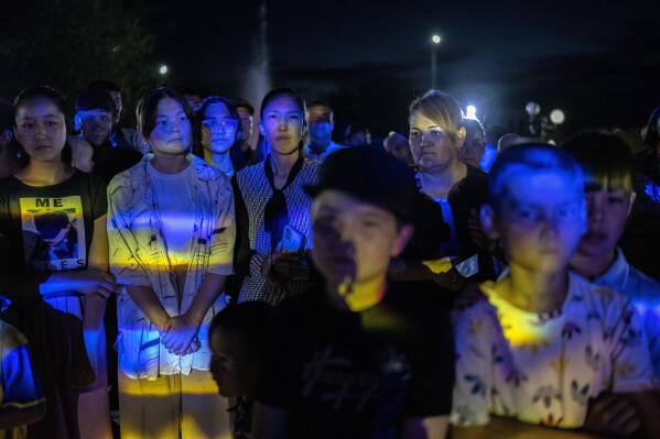 People attend a local concert in a park in Muynak, Uzbekistan, Monday, June 26, 2023. (AP Photo/Ebrahim Noroozi)