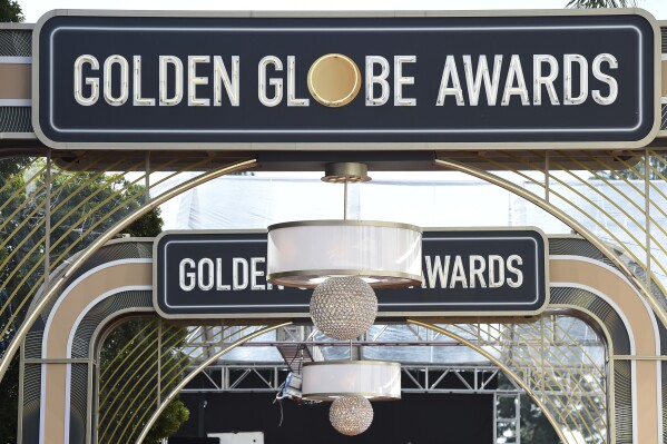 FILE - Event signage appears above the red carpet at the 77th annual Golden Globe Awards, Sunday, Jan. 5, 2020, in Beverly Hills, Calif. The 2024 Golden Globe Awards will be broadcast on CBS. (Photo by Jordan Strauss/Invision/AP, File)