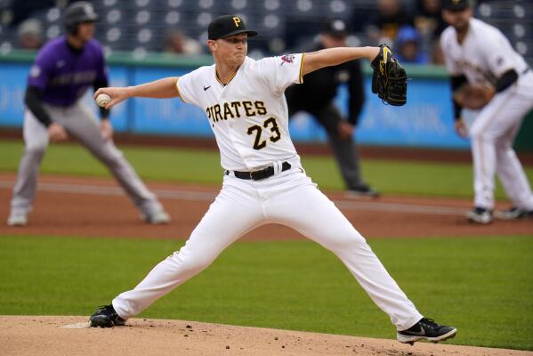 Pittsburgh Pirates starting pitcher JT Brubaker, left, tags out