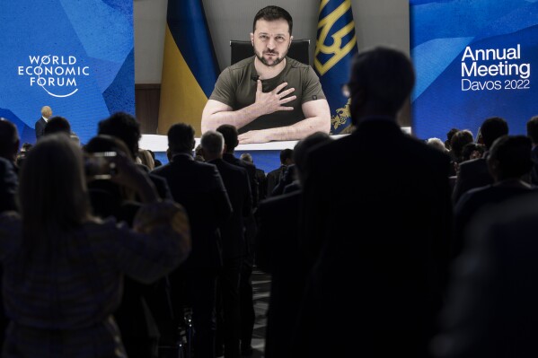 FILE - Ukrainian President Volodymyr Zelenskyy addresses the opening plenary session by videolink during the 51st annual meeting of the World Economic Forum, WEF, in Davos, Switzerland, Monday, May 23, 2022. More than 60 heads of state and government and hundreds of business leaders are coming to Switzerland to discuss the biggest global challenges during the World Economic Forum's annual gathering next week, ranging from Israeli President Isaac Herzog to Ukrainian President Volodymyr Zelenskyy. (Laurent Gillieron /Keystone via AP, File)