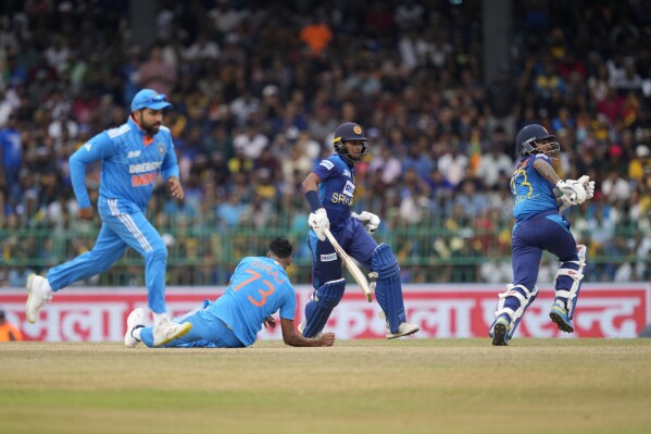 India's Mohammed Siraj loses his balance after delivering a ball as Sri Lanka's Dunith Wellalage and Kusal Mendis run between wickets during the Asia Cup final cricket match between India and Sri Lanka in Colombo, Sri Lanka, Sunday, Sep. 17, 2023. (AP Photo/Eranga Jayawardena)