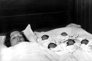 Elzire Dionne is shown with her five girls shortly after their birth in Corbeil, near Callander in northern Ontario, Canada, on May  28, 1934.  The identical quintuplets, born at least two months premature, are the first known quintupletes to survive infancy.  (AP Photo)