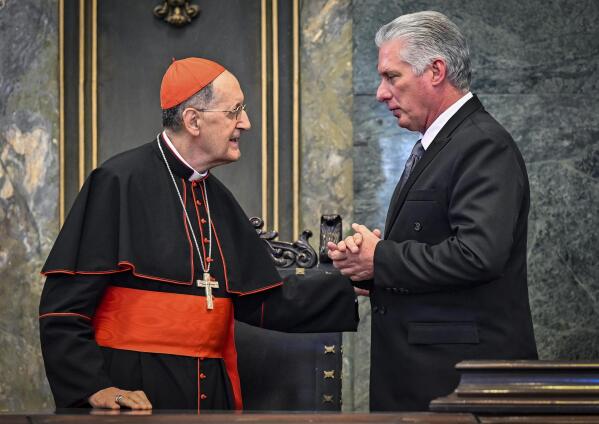Cuban President Miguel Diaz Canel, right, talks with Cardinal Beniamino Stella during a ceremony marking the 25th anniversary of St. Paul II's apostolic journey to Cuba, at Havana University in Havana, Cuba, Wednesday, Feb. 8, 2023. Stella arrived in Cuba as Pope Francis’ special envoy on Jan. 24. (Adalberto Roque/Pool photo via AP)