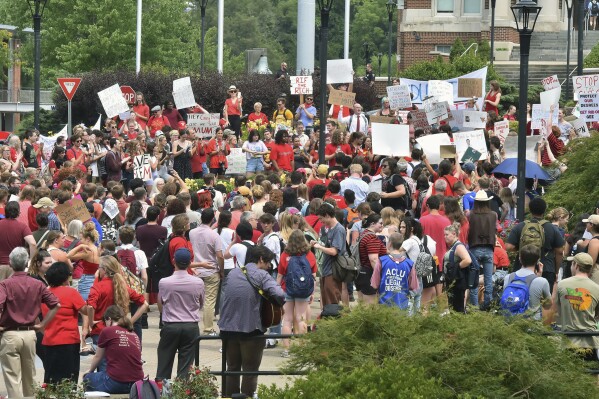 FILE - Students gather during a walkout in protest of an administration proposal to cut 9% of majors and amid a $45 million budget shortfall at West Virginia University in Morgantown, W.Va., Monday, Aug. 21, 2023. West Virginia University is recommending slashing its language department and dozens of other programs amid a $45 million budget shortfall. (Ron Rittenhouse /The Dominion-Post via AP, File)