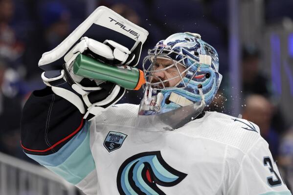 Seattle Kraken goaltender Philipp Grubauer (31) sprays water on his face in the second period of an NHL hockey game against the New York Islanders on Wednesday, Feb. 2, 2022, in Elmont, N.Y. (AP Photo/Adam Hunger)