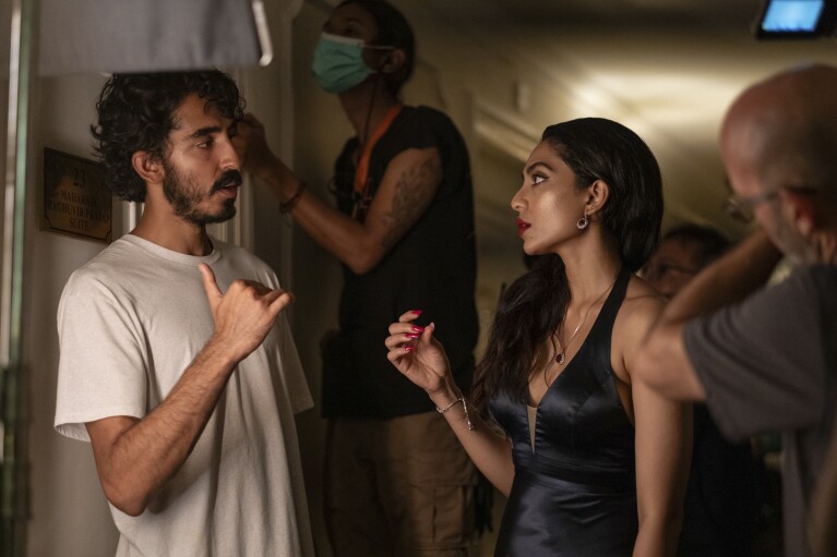 This image released by Universal Pictures shows Dev Patel, left, and Sobhita Dhulipala on the set of "Monkey Man." (Akhirwan Nurhaidir/Universal Pictures via AP)