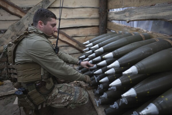 A Ukrainian officer of the 92nd separate assault brigade inspects ammunition in a shelter on the frontline near Vovchansk, Kharkiv region, Ukraine, Monday, Oct. 28, 2024. (AP Photo/Efrem Lukatsky)