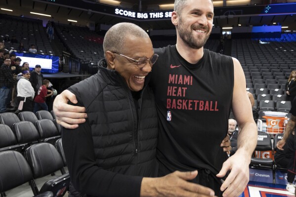 Miami Heat forward Kevin Love, right, embraces Alvin Gentry, left, Sacramento Kings vice president of basketball engagement, before warmups prior to an NBA basketball game in Sacramento, Calif., Monday, Feb. 26, 2024. (AP Photo/José Luis Villegas)