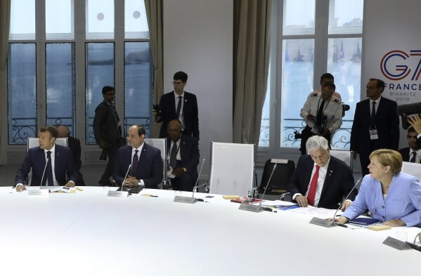 From the left, French President Emmanuel Macron, Egyptian President and Chairman of the African Union Abdel Fattah al-Sissi, Chile's President Sebastian Pinera and German Chancellor Angela Merkel attend a work session focused on climate in Biarritz, southwestern France, Monday Aug. 26, 2019, on the third day of the annual G7 Summit. The empty seat at third right was the place reserved for President Donald Trump, who according to Macron had skipped Monday's working session on the climate. At the same time Macron said that Trump supported an initiative by G-7 countries for an immediate $20 million fund to help Amazon countries fight wildfires and launch a long-term global initiative to protect the rainforest. (Ludovic Marin, Pool via AP)